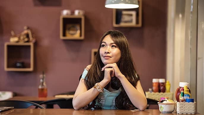 woman thinking in a restaurant