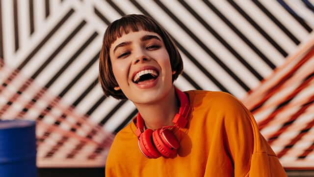 happy woman with short-hair posing on striped background