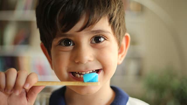 Kid brushing his teeth