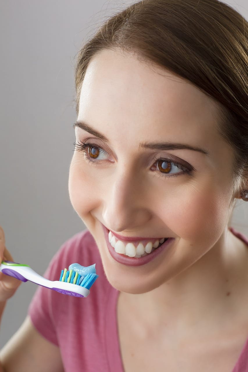 colgate ile dişlerini fırçalayan kadın