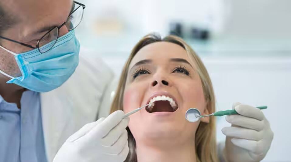 Lady getting a dental checkup for plaque on teeth