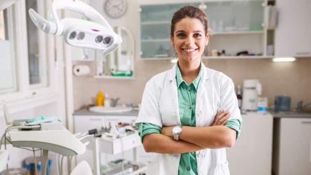 Portrait of female dentist standing in her dentist's office