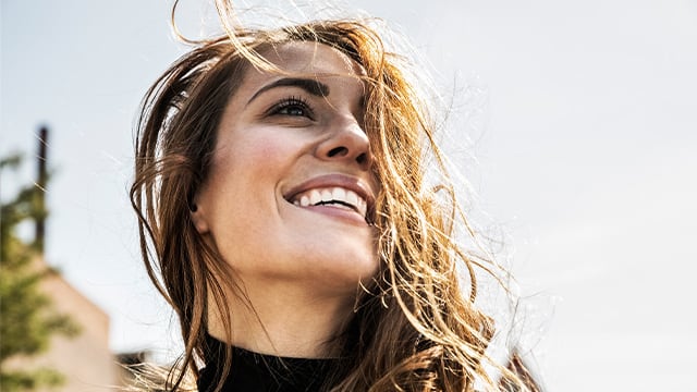 Portrait of happy woman with blowing hair