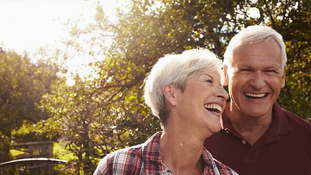 Senior Couple smiling outside