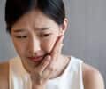 Woman having a tooth pain