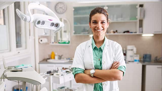 A dental hygienist in her office