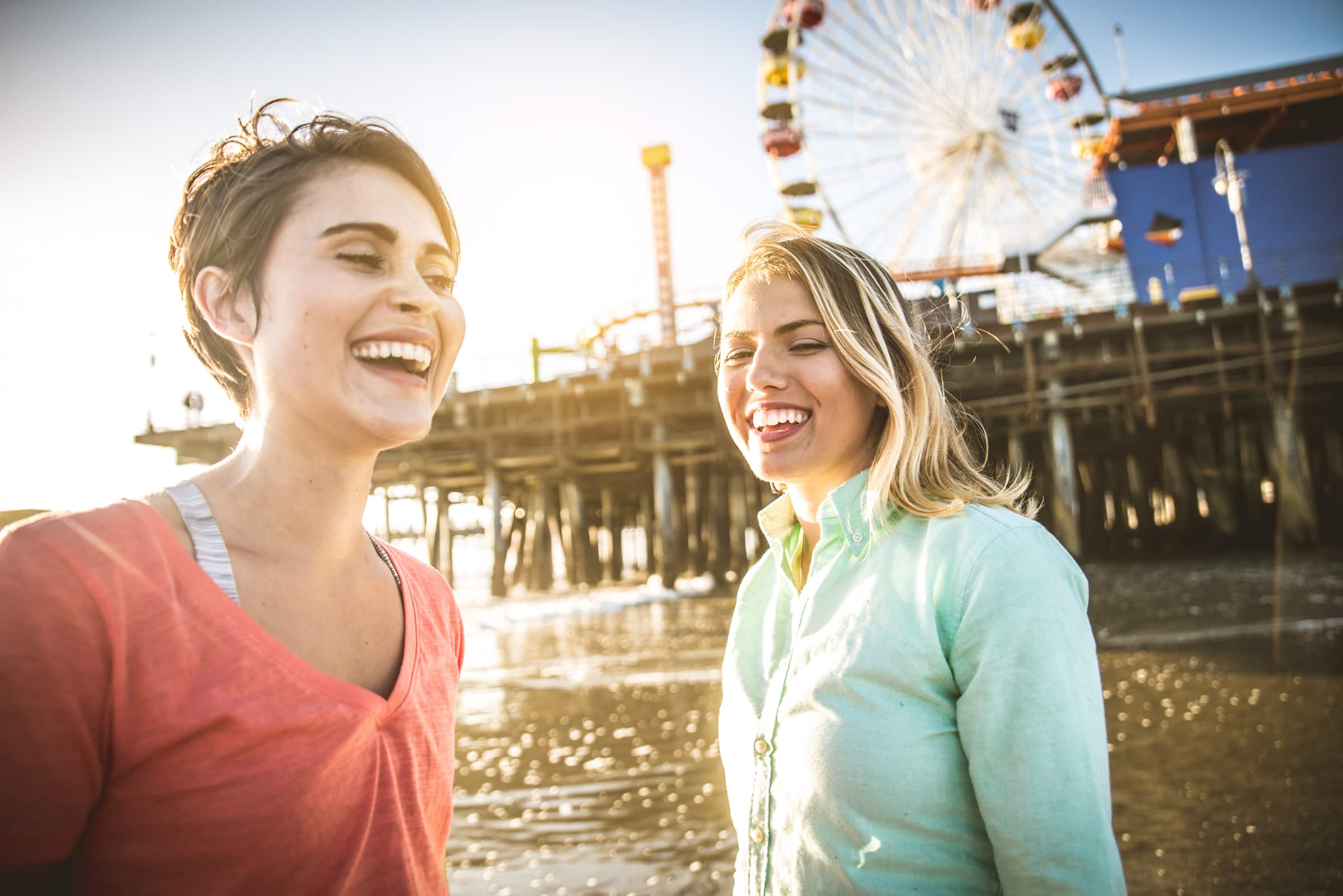 two friends having fun at a pier