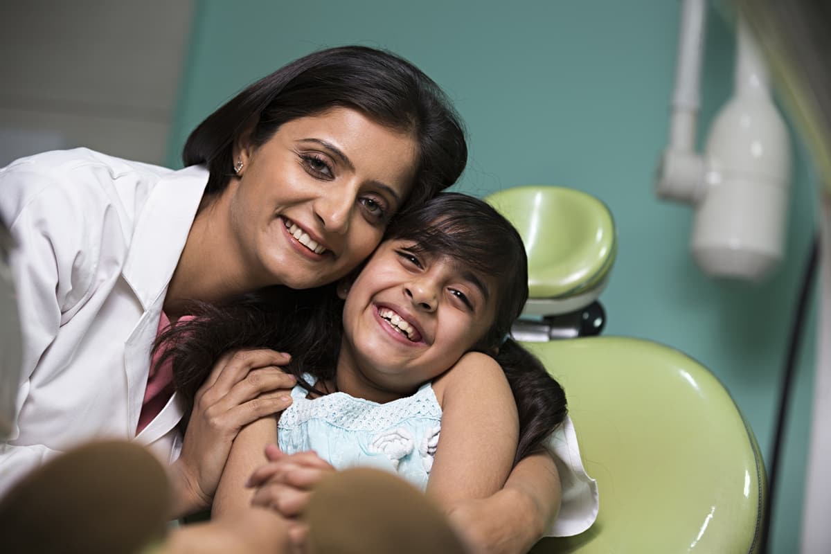Pediatric dentist smiling with her patient