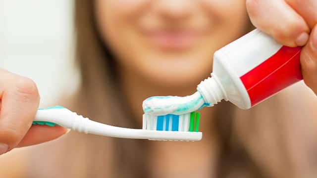 woman smiling with her toothpaste