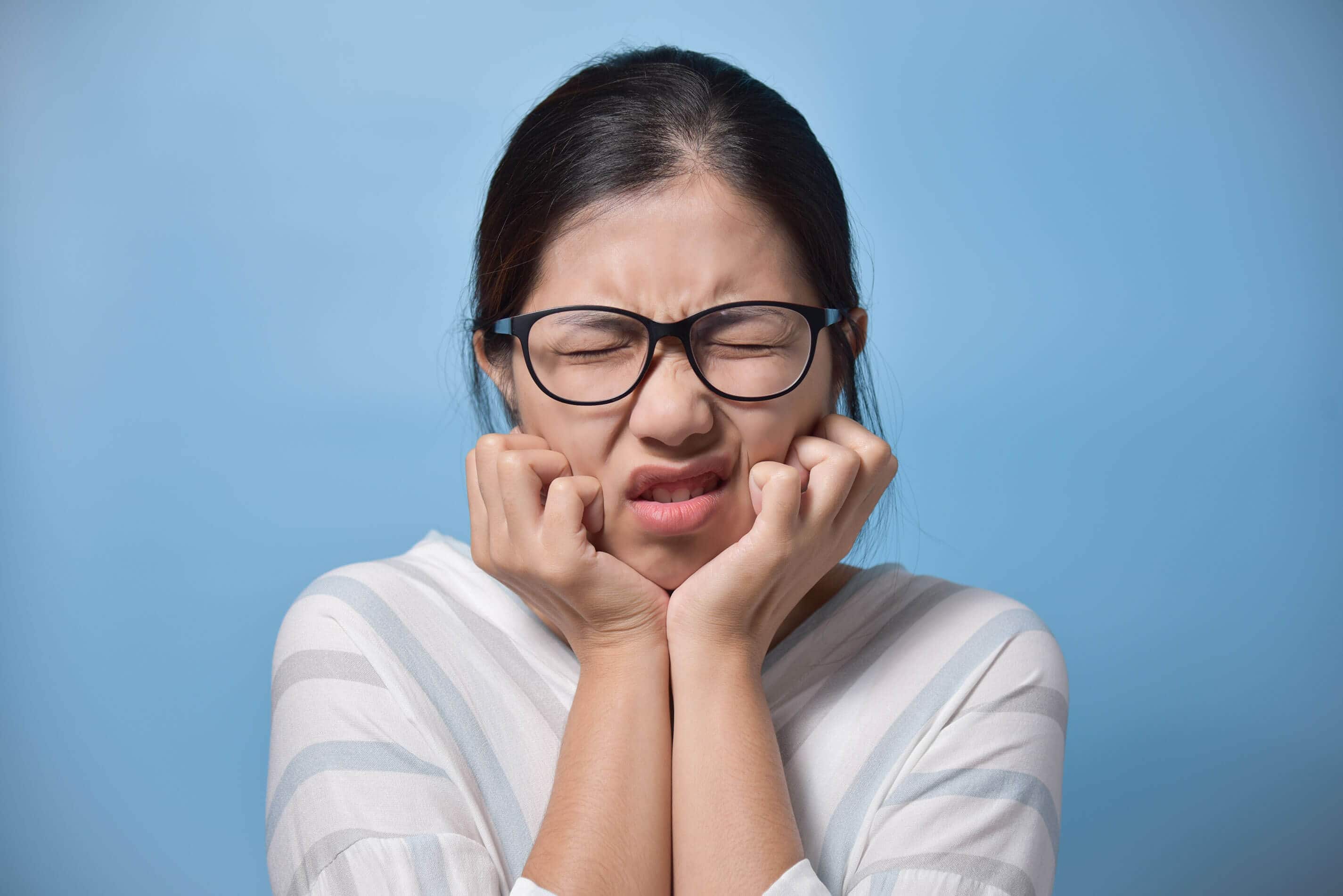 toothache concept frustrated young asian glasses