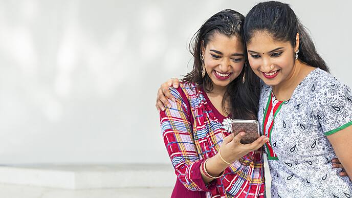girls looks at cell phone