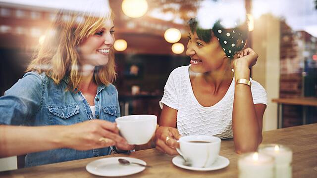 Two friends having a cup of coffee