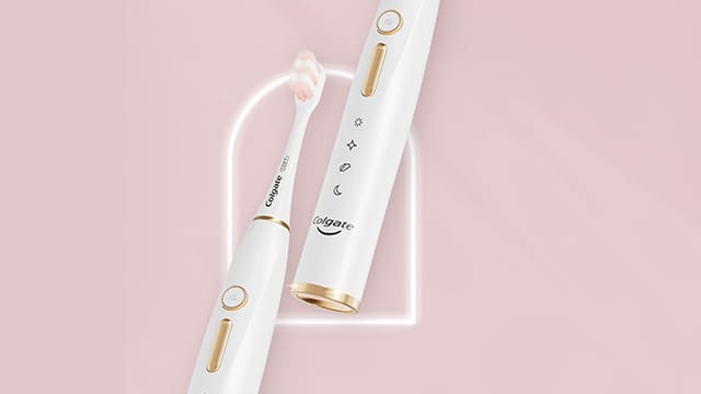 Electric toothbrush in a pink background