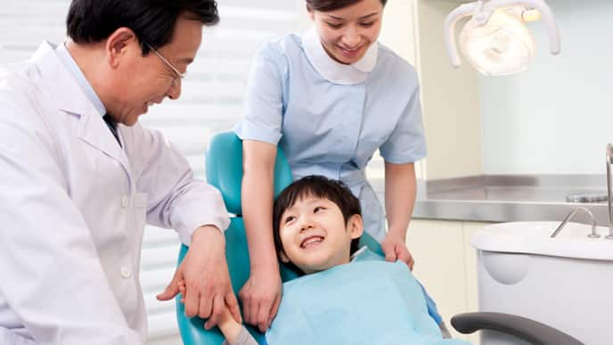 a pediatric dentist explaining to his patient a treatment