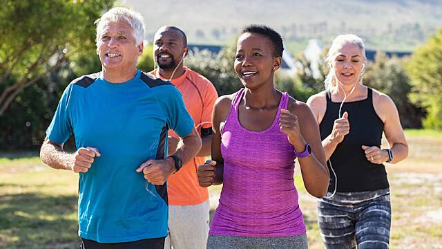 Mature and senior people jogging at park