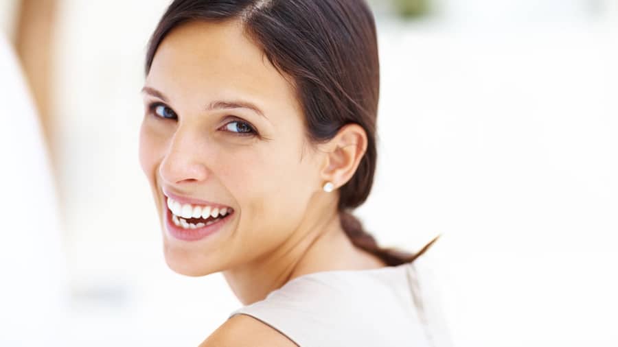 a woman with beautiful smile after using whitening gel at home