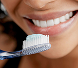Women brushing her teeths