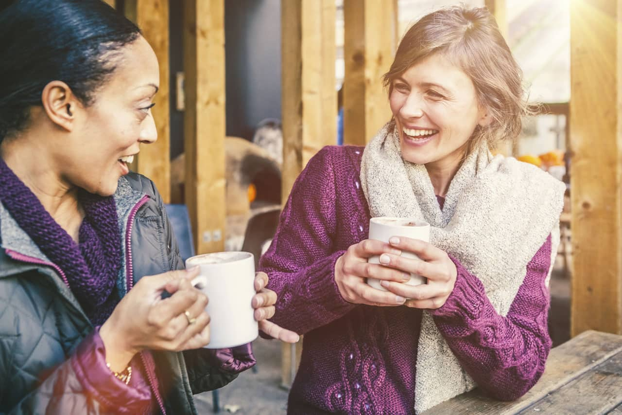 two persons enjoying a warm cup of coffee