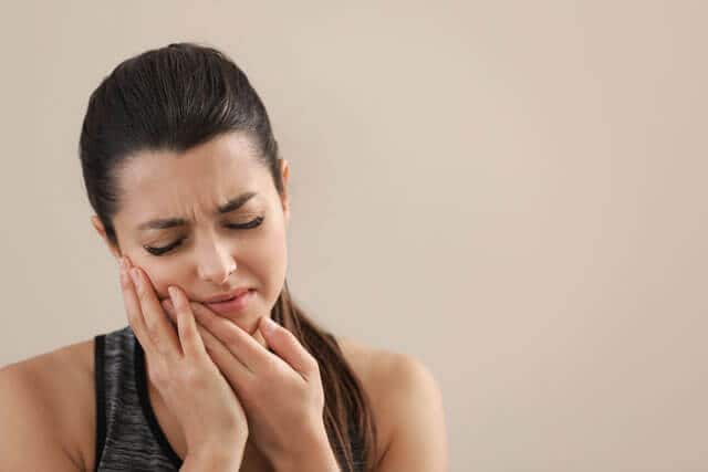 Mujer joven con dolor en la boca