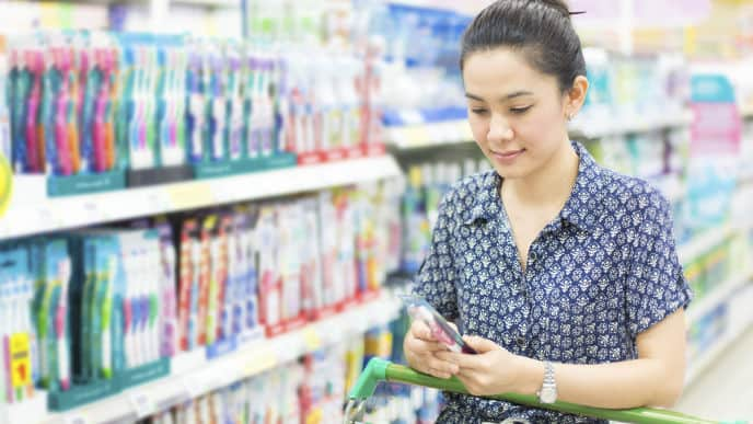 woman shopping for a Colgate toothbrush