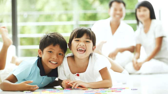 two kids showing teeth