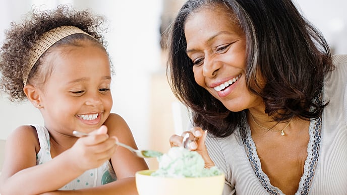 grandmother eating ice cream with granddaughter