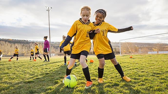 young girls playing soccer