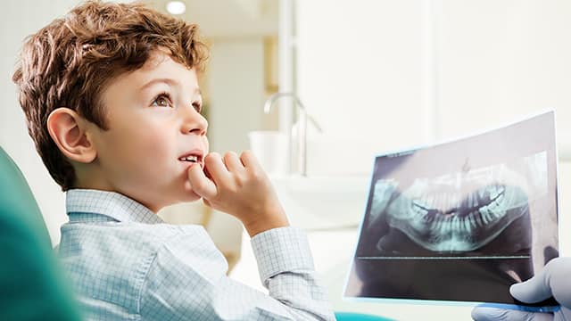 boy looking at dental xray
