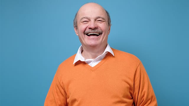 man smiling while laughing