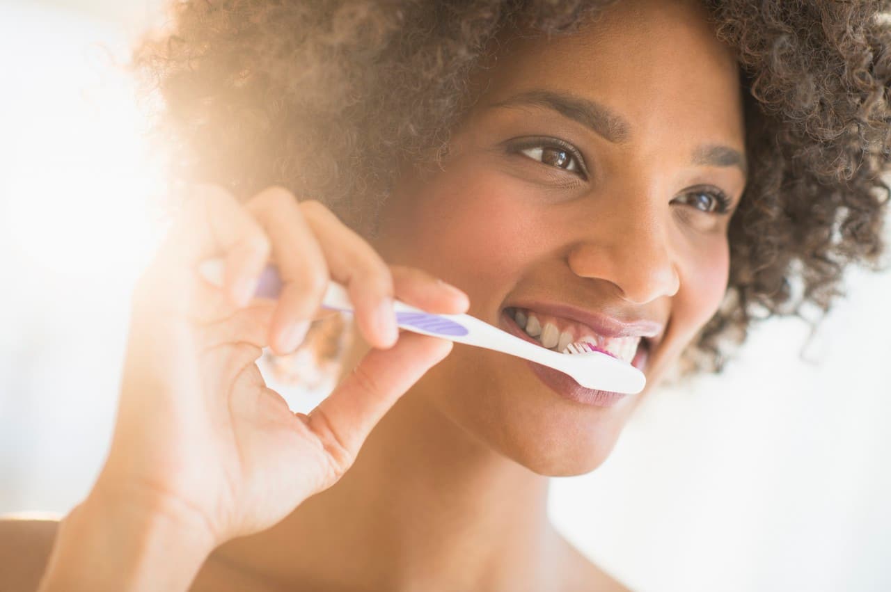 Portrait of woman brushing teeth