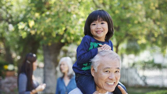 grandfather giving his granddaughter a piggyback ride