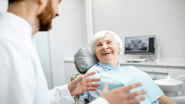 older woman with sitting during the consultation with dentist at the dental office.
