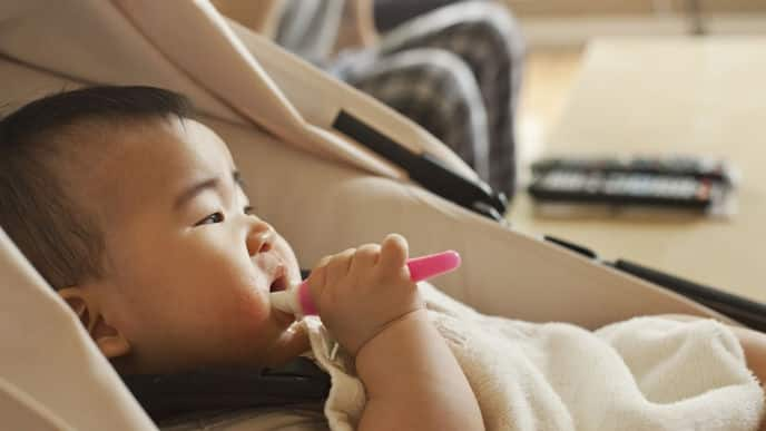 baby with a toddler toothbrush