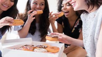 young people sharing doughnuts