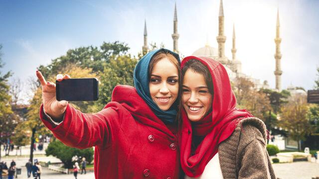 Two women smiling while taking a selfie