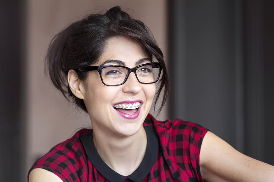 A woman is smiling with braces