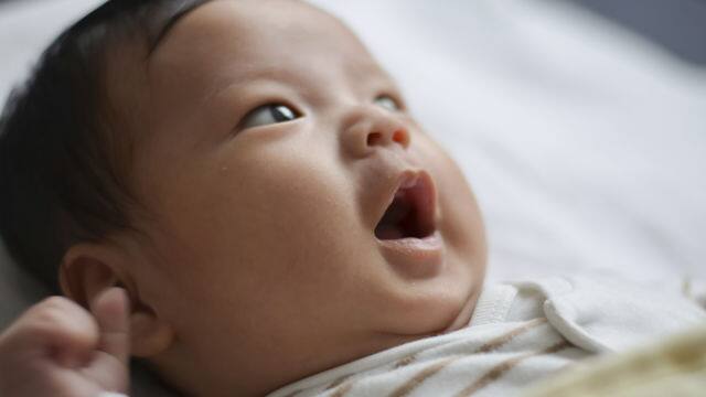 baby in crib smiling