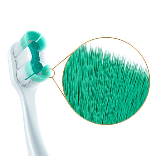 Colgate<sup>®</sup> Total Foaming Clean brush head with an inset image of the slim-tip bristles