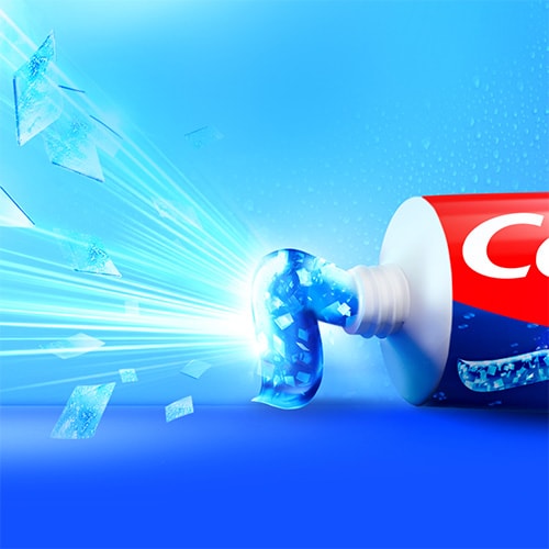 The Colgate MaxFresh toothpaste bursting out with freshness and cooling crystals from the tube