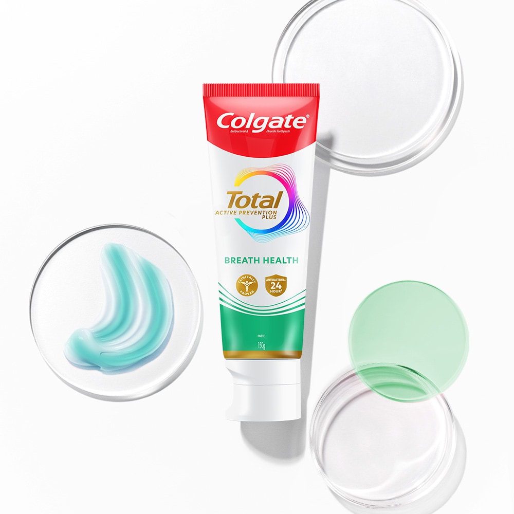 Colgate Total toothpaste tube in the foreground, with transparent and spectrum bubbles in the background