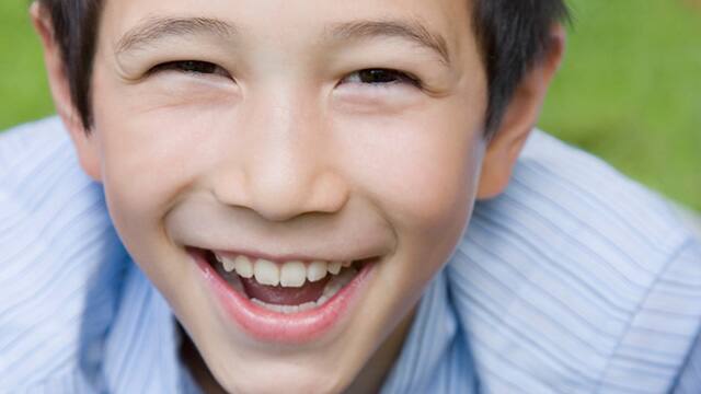 a boy smiling brightly