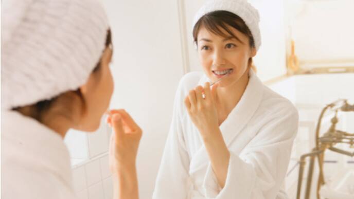 a man brushing and flossing his teeth