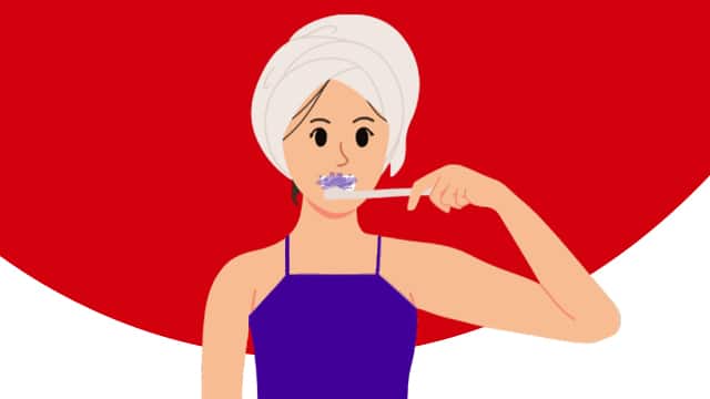 A girl brushing her teeth, showcasing light purple foam from Colgate Optic White Purple Toothpaste.